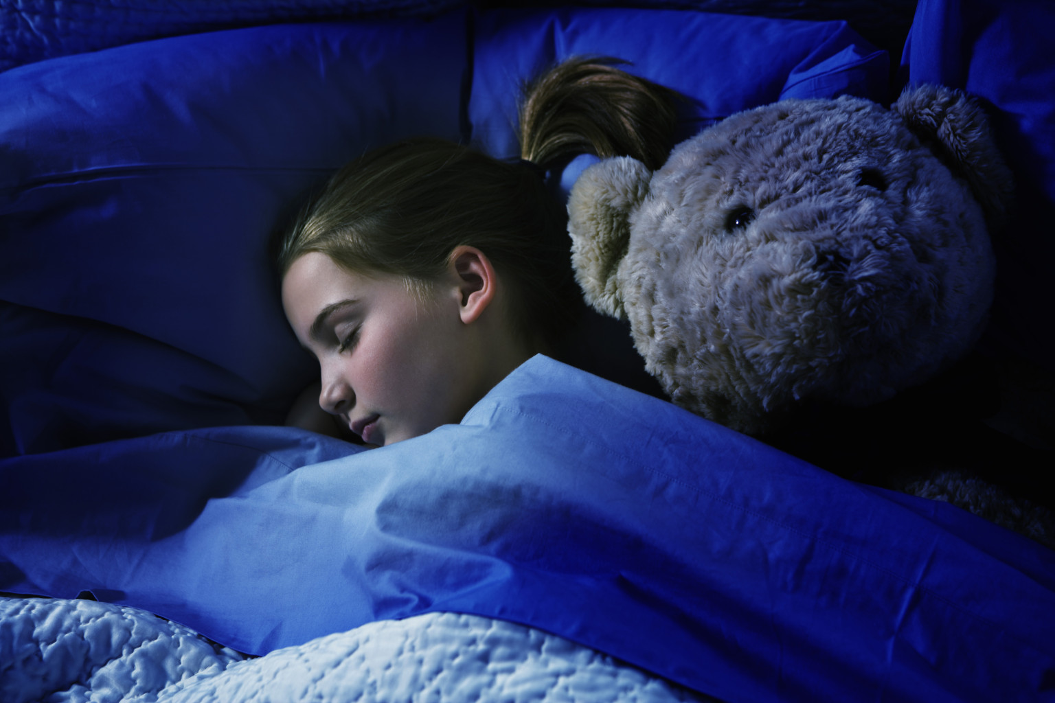 Sleeping girl with teddy bear